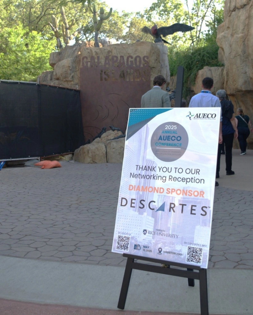 Event signboard positioned in front of the aquarium at the Houston Zoo, announcing the Descartes-sponsored happy hour for AUECO 2025, where university compliance professionals and partners networked in a unique underwater setting.