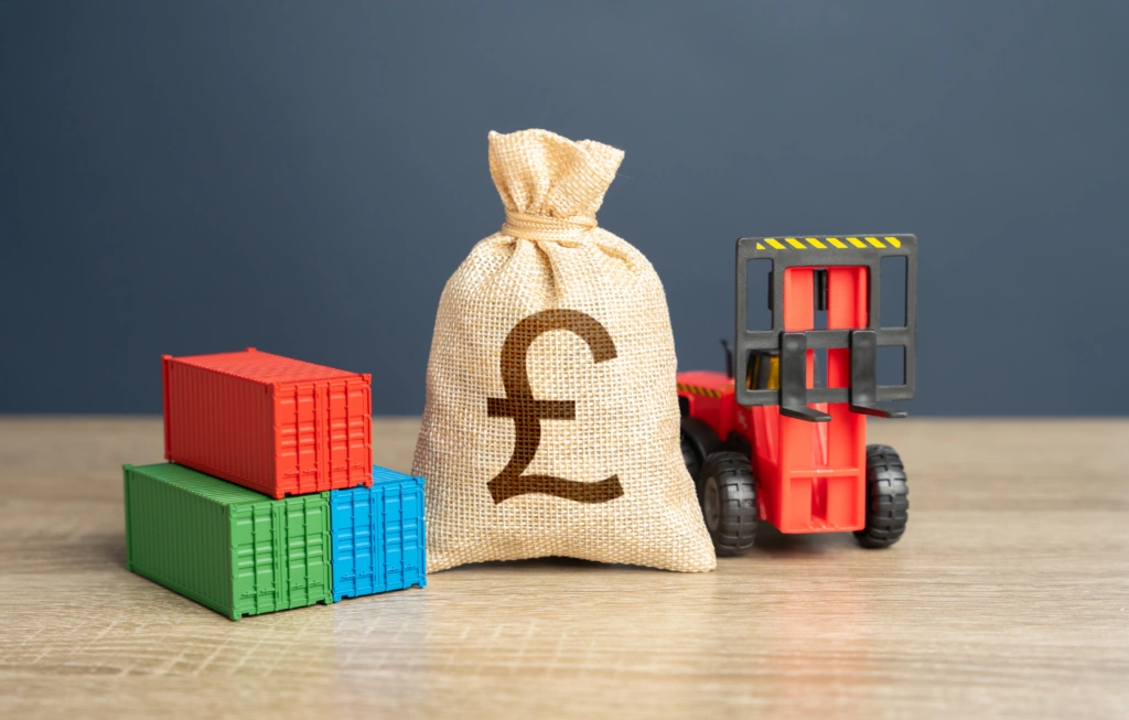 UK Record Export Control Fine: Sanctions Compliance with containers, money bag and forklift figurines