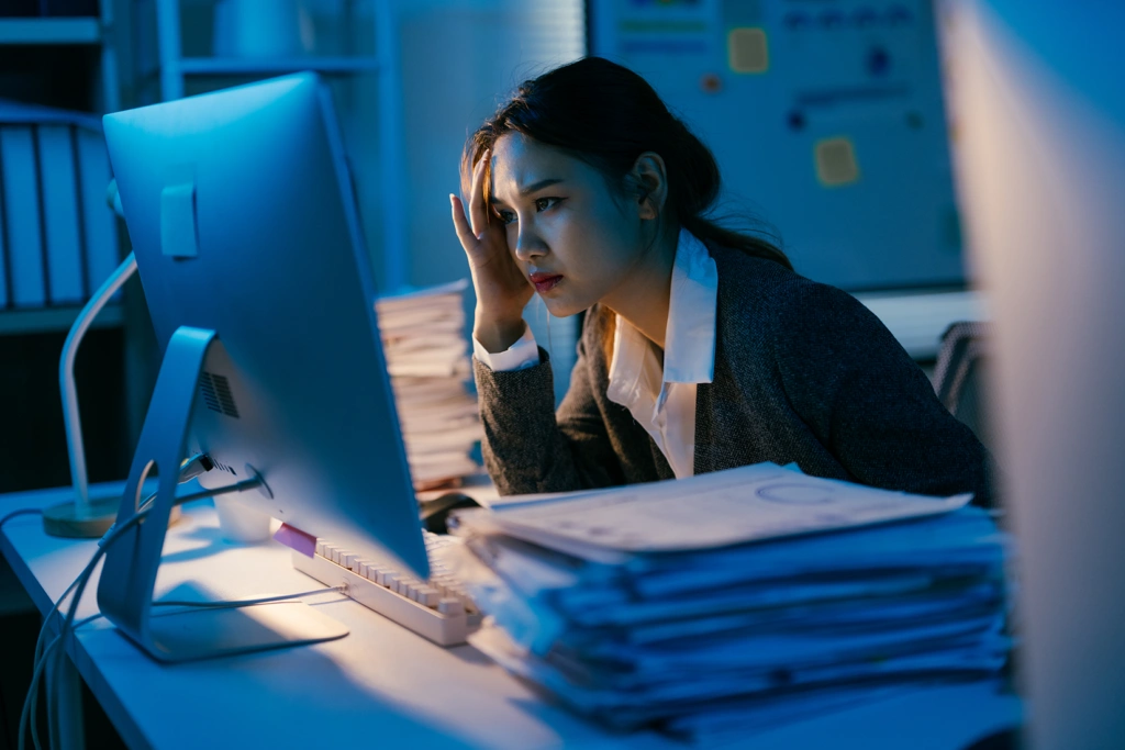Compliance professional looking at backlog of sanctions screening results to review